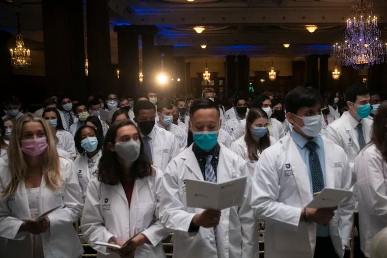 Sidney Kimmel Medical College students read the Hippocratic oath last month. All college students in Philadelphia will have to be vaccinated by October, the city announced today.