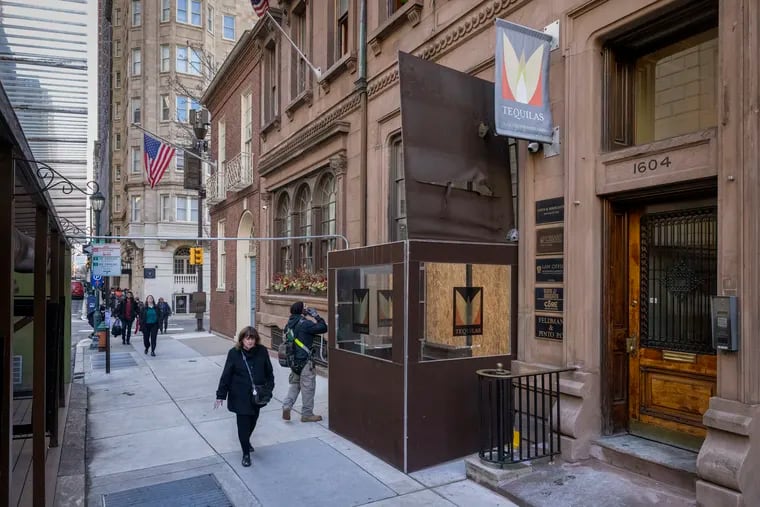 Tequilas at 1602 Locust St. as seen on the morning of Feb. 10, 2023, after a fire the night before. Its vestibule roof has been raised and the front door is covered in playwood.