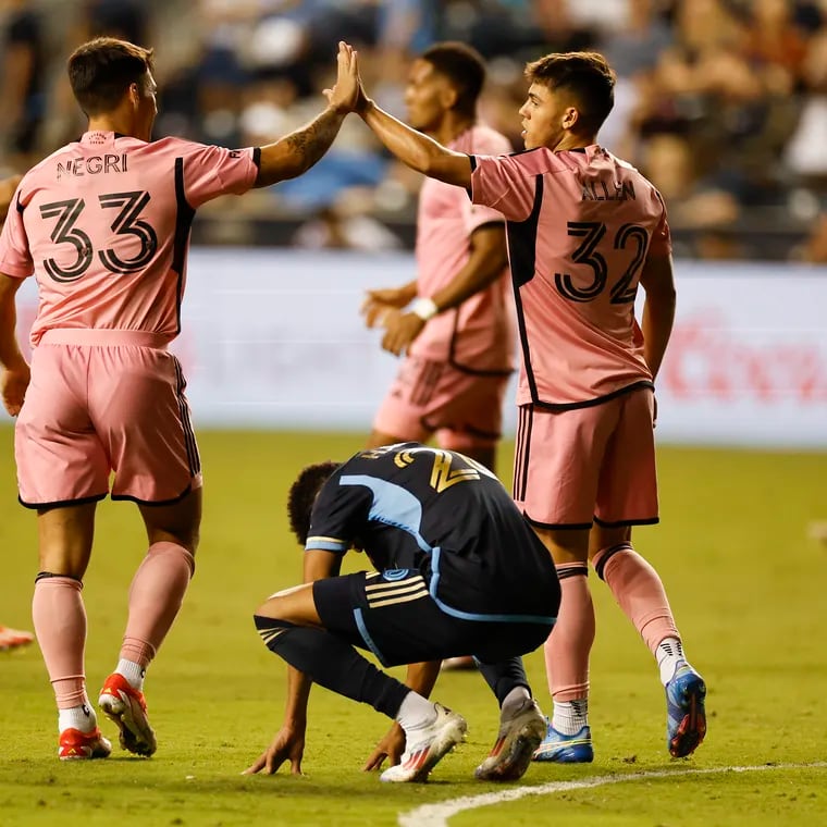 Union defender Nathan Harriel kneels to the pitch as Inter Miami defender Franco Negri (left) and teammate defender Noah Allen celebrate their 2-1 win over the Union.