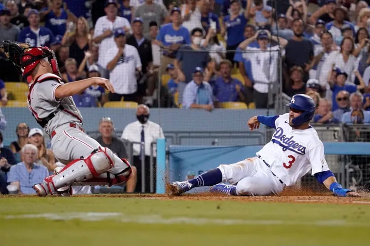 The Dodgers' Chris Taylor scored ahead of a tag from Phillies catcher J.T. Realmuto during a game in Los Angeles in June.