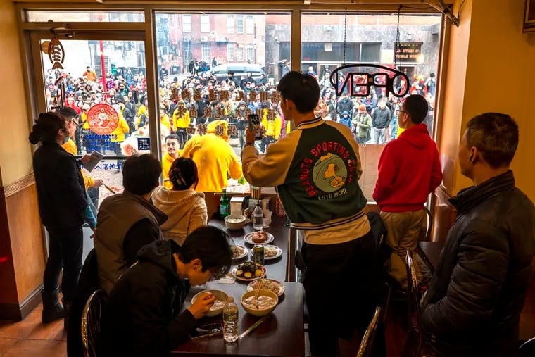 Diners watch from inside Ming River Side Walk House on North 10th Street.