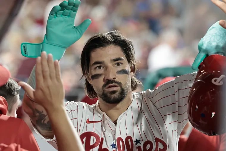 Nick Castellanos gets high fives after scoring the Phillies' go-ahead run. He hit his 20th home run of the season in the first inning.