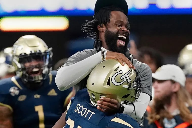 Georgia Tech defensive lineman Makius Scott celebrates with defensive line coach Larry Knight after a defensive stop during a game against North Carolina Saturday, Sept. 25, 2021, in Atlanta.