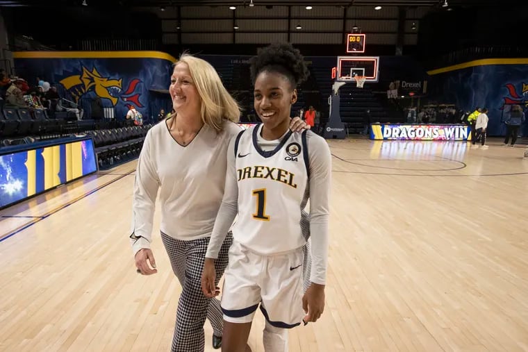 Keishana Washington (right) of Drexel and coach Amy Mallon walk off the court. Washington finished as the second all-time leading scorer at Drexel with 2,363 career points.
