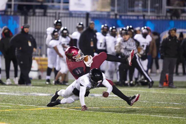 St. Joe's Prep wideout Johnny Freeman (11) catches a pass across the middle against Harrisburg in the PIAA Class 6A final at HersheyPark Stadium.