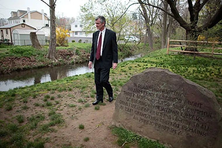 Michael T. Sellers of Newtown Borough Council stands next to Newtown Creek, which a Bucks County group has been rallying to restore to its former place of prominence in the historic town. (David Swanson / Staff Photographer)