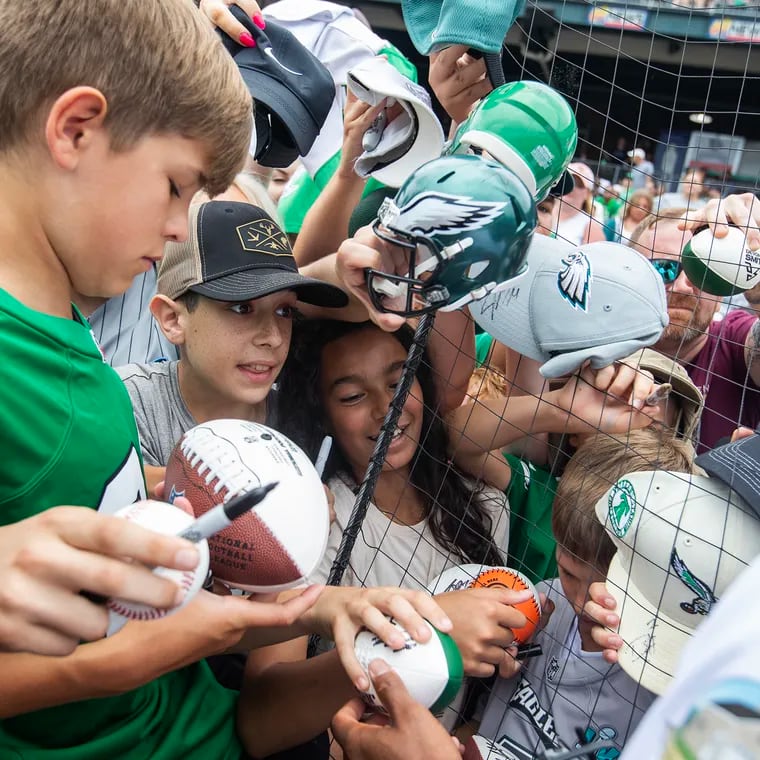 Fans clamor for autographs from Saquon Barkley at DeVonta Smith's celebrity  softball game and home run derby on June 29, 2024.  The event was held at Coca-Cola Park in Allentown.