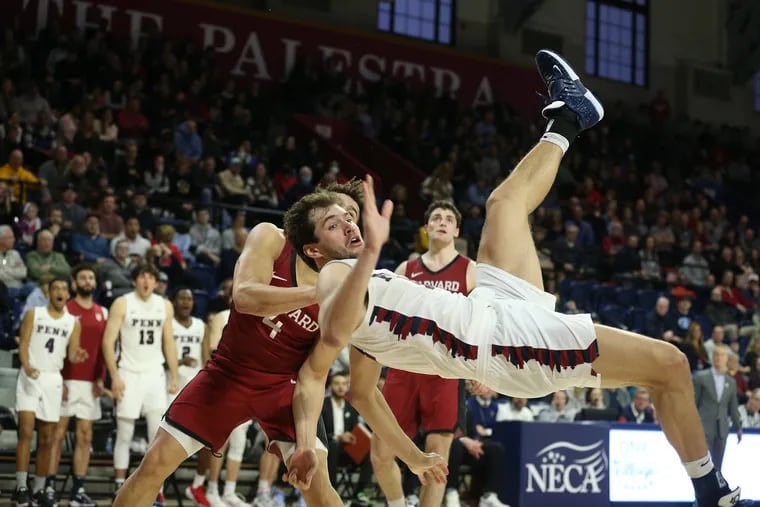 Max Martz of Penn gets upended after a hard foul by Chris Ledlum of Harvard during the 2nd half of their game at The Palestra on Ja. 28, 2023. It was ruled a flagrant 1 foul.