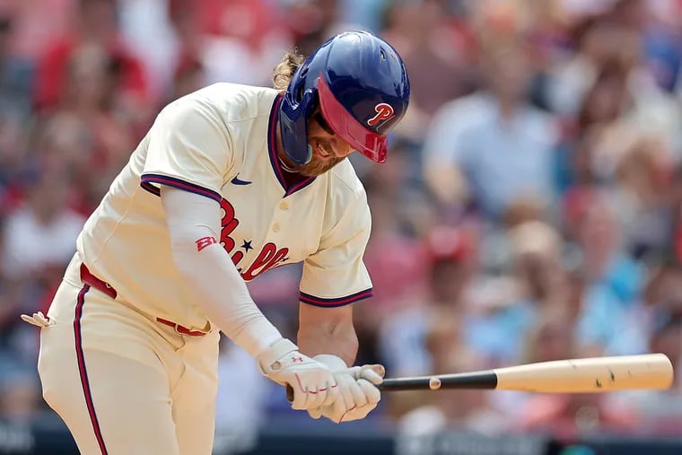 Phillies first base Bryce Harper tossing his bat in frustration after flying out in the bottom of the seventh inning against the Cleveland Guardians on Sunday.