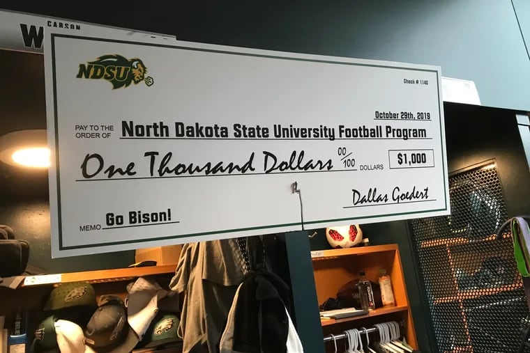 A larger-than-life check from Eagles tight end Dallas Goedert to the North Dakota State football program for $1,000. Goedert lost a bet with Bison alum Carson Wentz.