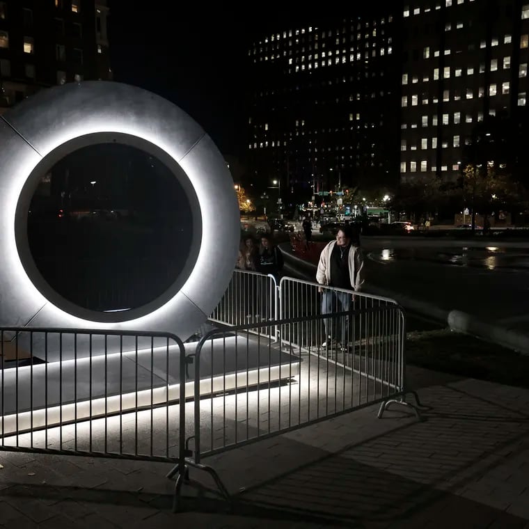 Visitors look over a Portals art installation, which features live streaming video between two international locations, in Philadelphia’s Love Park on Friday, October 18, 2024. The installation did not appear to be complete.