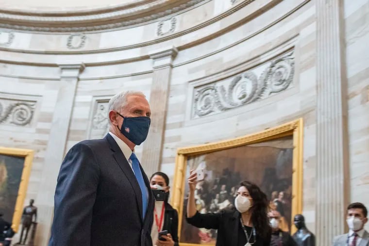 Vice President Mike Pence heads through the Capitol Rotunda into the House chamber for the electoral college count on Jan. 6.