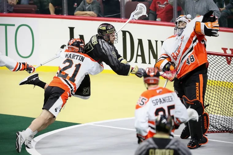 The Bandits' Matt Vinc (48) blocks a shot by the Wings' Josh Currier (27) as he is taken down by the Bandits' Justin Martin (21) during the Wings' inaugural game since returning to Philadelphia at the Wells Fargo Center in South Philadelphia on Saturday, Dec. 15, 2018. The Wings lost 17-15.