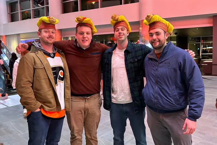 Xander Utecht (from left), Miles Macaleer, Cole Harper, and Brad Allan at the Wells Fargo Center Monday for the Flyers' Dollar Dog Night against the St. Louis Blues.