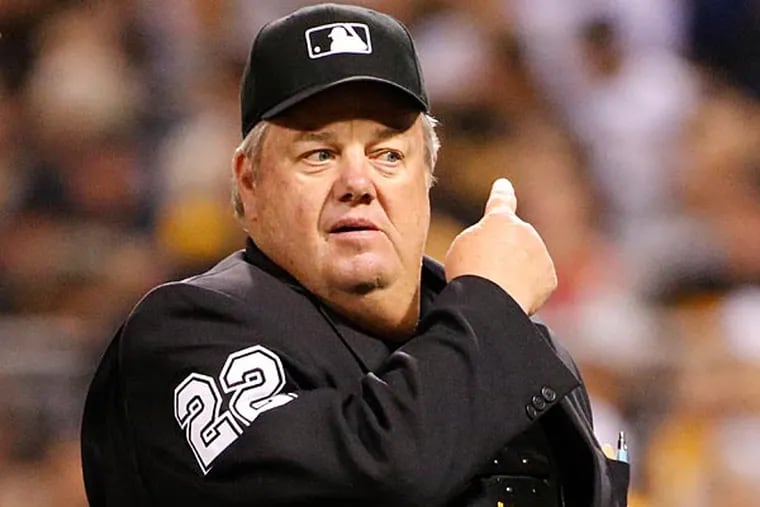 Umpire Joe West works a baseball game between the Pittsburgh Pirates
and the Milwaukee Brewers at PNC Park in Pittsburgh Friday, Sept. 19,
2014. (Gene Puskar/AP)