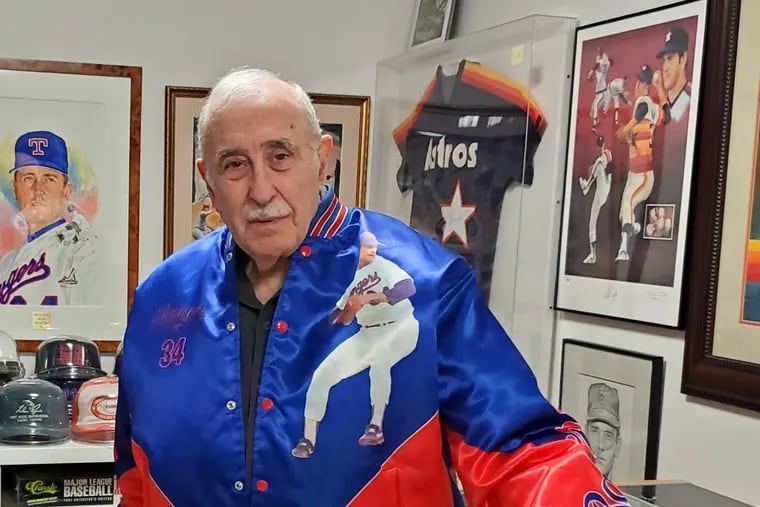Leo S. Ullman wearing a Nolan Ryan baseball jacket with a Nolan Ryan saddle and memorabilia from his vast collection in his home before he donated it to Stockton University.