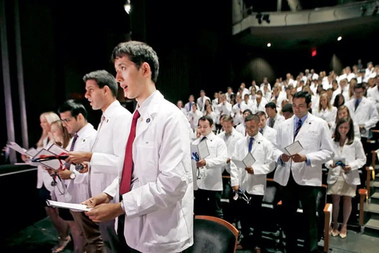 First-year medical students at Penn’s Perelman School of Medicine recite the Hippocratic oath during a “white coat ceremony” in Zellerbach Theatre at the Annenberg Center.