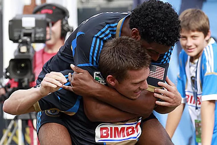 Antoine Hoppenot celebrates with Sheanon Williams after scoring the Union's third goal. (Yong Kim/Staff Photographer)