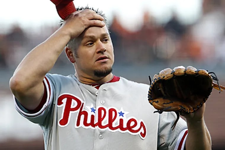 Joe Blanton reacts after throwing a wild pitch in the first inning of Game 4 of the NLCS. (Yong Kim / Staff Photographer)