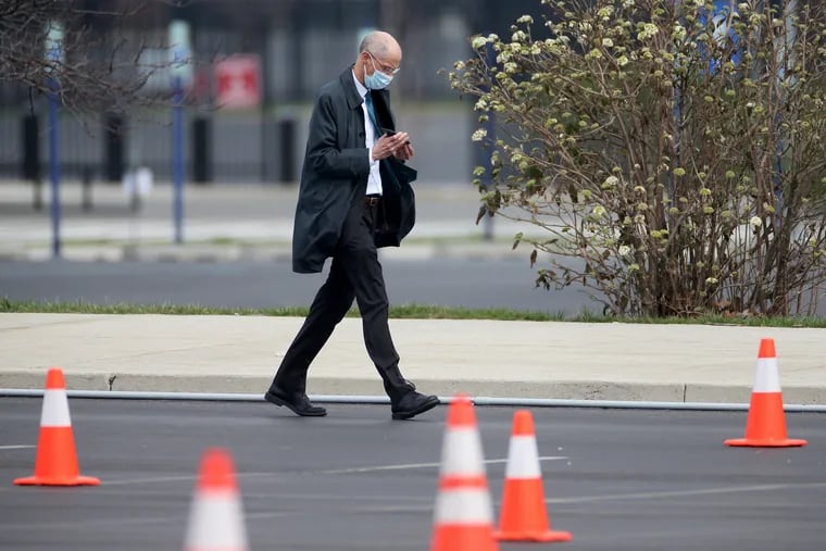 Philadelphia Health Commissioner Thomas Farley wears a mask as he walks through a city coronavirus testing site next to Citizens Bank Park in March.