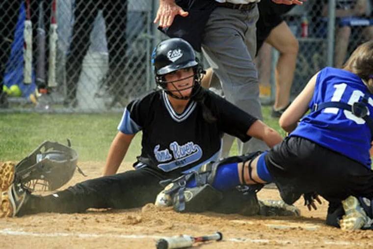 Toms River's Alyssa Paul is safe at home during the second inning as Williamstown catcher Chrissy Tamburrino is unable to make the tag. (Akira Suwa / Staff Photographer)
