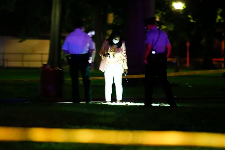 Philadelphia police investigate a shooting inside Malcolm X Park at 52nd Street and Larchwood Avenue in West Philadelphia Saturday night. Police said two people were shot there.