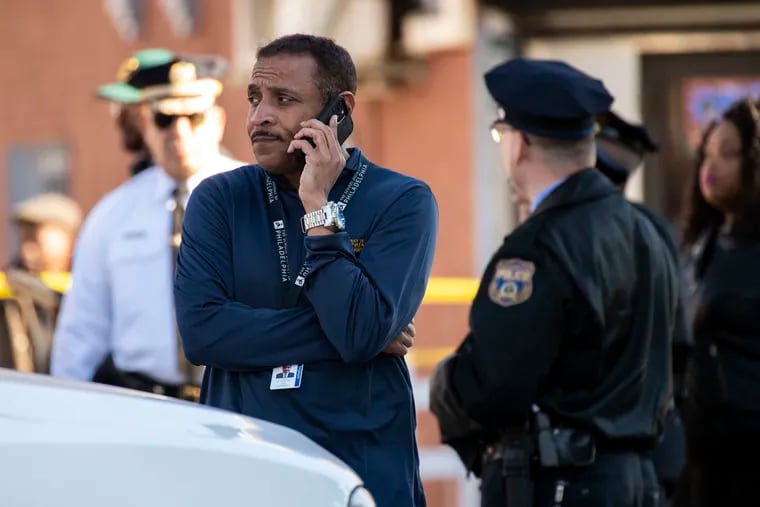 Superintendent Tony Watlington on the phone after a shooting at 60th and Oxford streets.