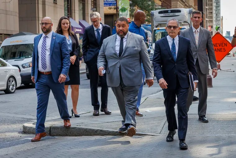 From left are Philadelphia City Commissioner Seth Bluestein, Chairman, Omar Sabir and District Attorney, Larry Krasner walking on South Broad Street on Monday, when they held a news conference to say they'll ensure that every Philadelphian's right to vote is protected in November.