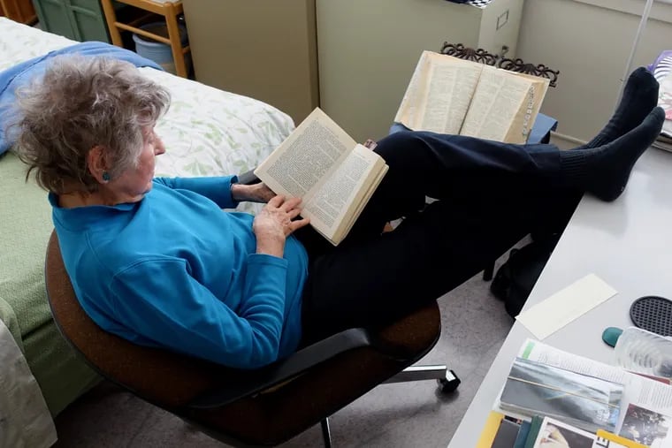 Dr. Hazard kicks back and reads in her study, the ever-present dictionary open and ready for consultation.