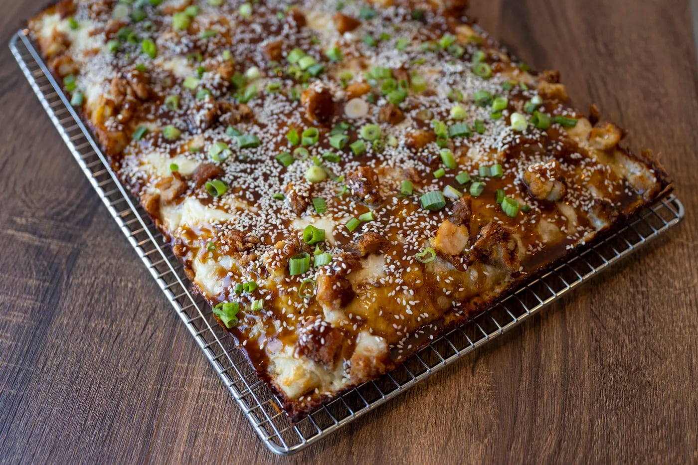 The K-pop at Bakeria 1010, a white pie topped with chicken, sesame seeds, scallions, and a sweet Korean barbecue sauce.