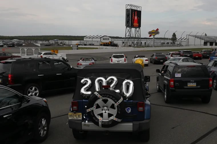 Balloons adorn a senior's car on the track during Jim Thorpe Area High School's graduation at Pocono Raceway in Long Pond, Pa., on Thursday, June 4, 2020. The racetrack is hosting several socially distanced Pennsylvania high school graduations due to the coronavirus pandemic.