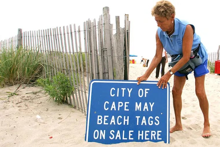 Jackie Rotz puts her Beach Tag sign outside her gate where she sells and validates beach tags in Cape May, N.J. in 2005. For Summer 2024, Cape May is unveiling a new digital cashless option to buying and displaying beach tags at the South Jersey beach.