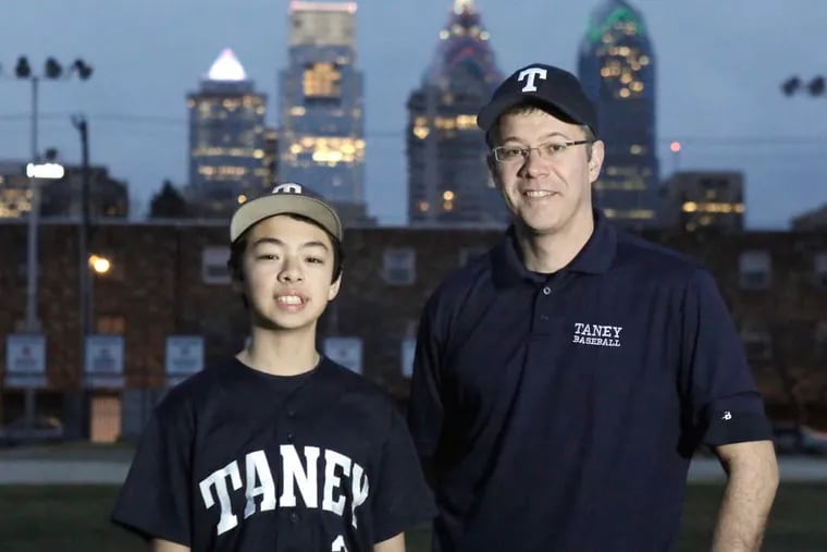 Taney Dragons Coach Alex Rice and his son Jack on the baseball field behind the Marian Anderson Rec Center.