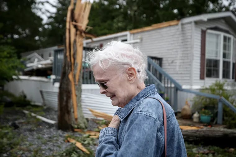 Ellen Mallen, who lives in Pine Hill Mobile Home Court, becomes emotional after seeing the damage to her home after an apparent tornado ripped through Marmora, N.J.