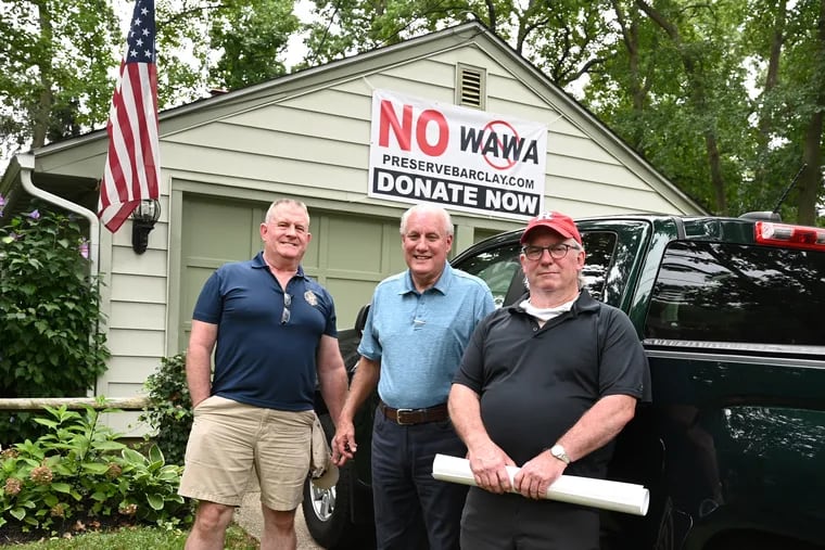 Cherry Hill residents (from left) Steve Walsh, Wes Hughes, and Bruce Sizer in front of Hughes' garage in the Barclay Farms neighborhood near the site of the proposed "super" Wawa.