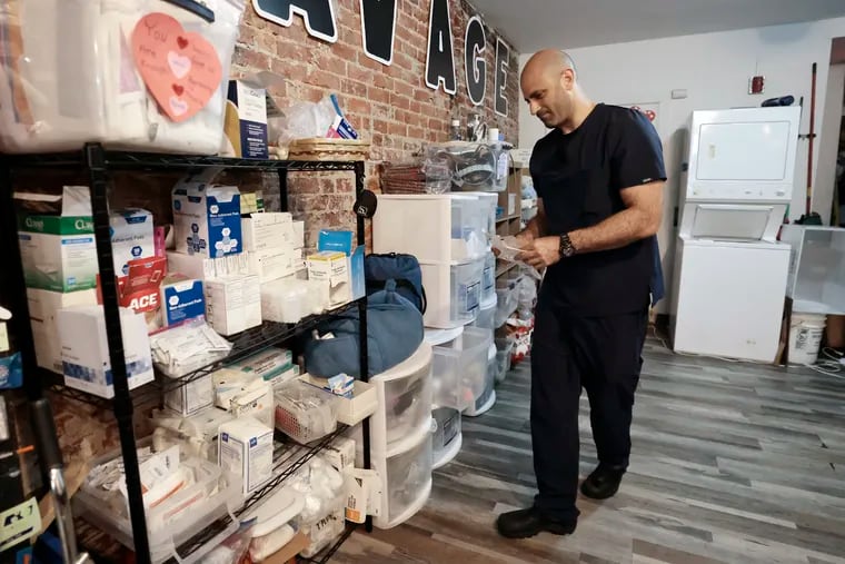 Jamaal Shaban puts medical supplies away after a wound training session at Savage Sisters, an addiction outreach nonprofit based in Philadelphia's Kensington neighborhood.