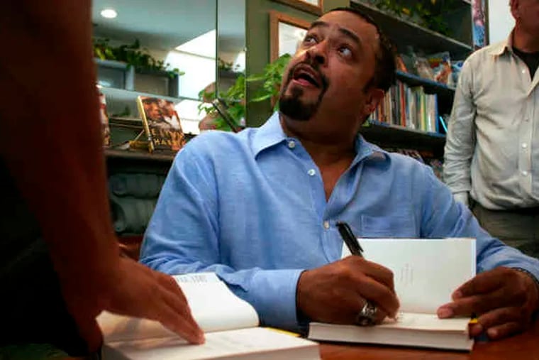 E. Lynn Harris signs a book at Giovanni's Room in 2006. The Philadelphia bookstore was one of the first to offer Harris a signing; later, when his works became best-sellers, the store was almost always a stop on his book tours.