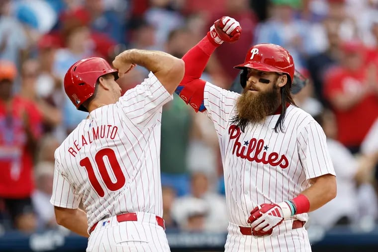 Brandon Marsh, right, and J.T. Realmuto were among the Phillies hitting golf balls to determine the draft order of their fantasy football league.