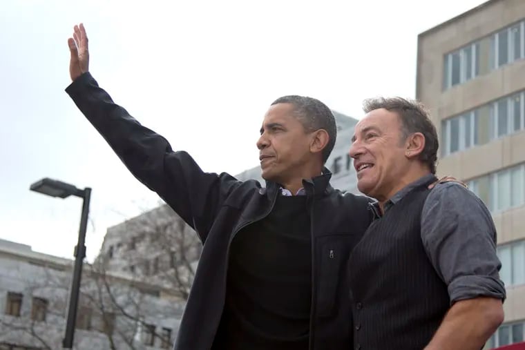 Former President Barack Obama waves to a Wisconsin crowd as he stands with singer Bruce Springsteen on stage after speaking at a campaign event in this 2012 file photo. Springsteen and Obama will campaign for Vice President Kamala Harris in Philadelphia on Monday.