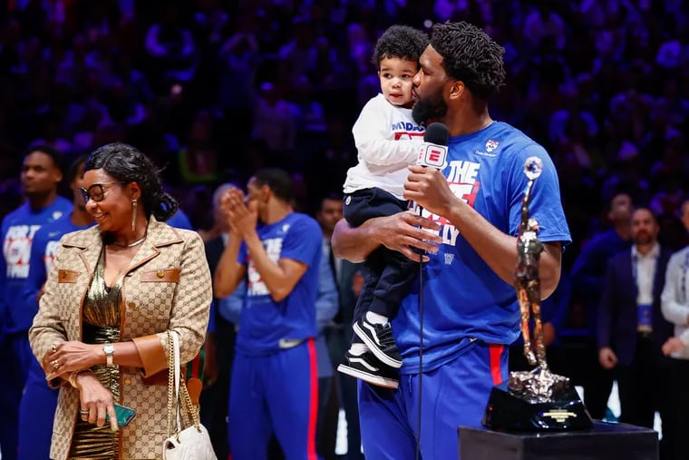 Sixers center Joel Embiid with his family after receiving the NBA MVP Michael Jordan Trophy during a ceremony before the start of Game 3 of the NBA basketball Eastern Conference semifinals playoff series at the Wells Fargo Center, Friday, May. 5, 2023, in Philadelphia.
