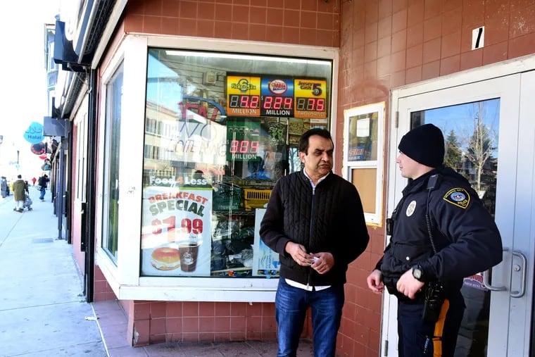 Owner Muhammad Zia (left) talks with Atlantic City Police Officer Ivaylo Ivanov (right) outside his Food 4 Less convenience store, as police and service groups do their daily outreach along Atlantic Avenue, March 5, 2019. Zia is now a councilmember.
