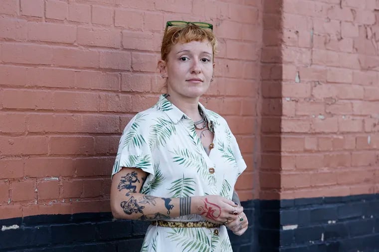 Former UArts instructor Su Güzey stands along the 1700 block of North Fifth Street in the Ludlow neighborhood of Philadelphia on Monday, Aug. 12, 2024.  She fears deportation due to the school's unexpected closure.