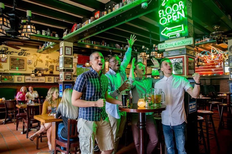 A group of friends cheer along to a game inside McGillinâ€™s Olde Ale House in Center City, Philadelphia. McGillin's is considered to be one of the oldest continuously operating taverns in the country.