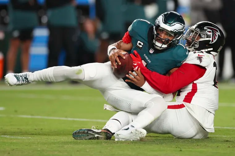 Eagles quarterback Jalen Hurts is sacked by Falcons linebacker Matthew Judon during the third quarter of Monday night's loss.