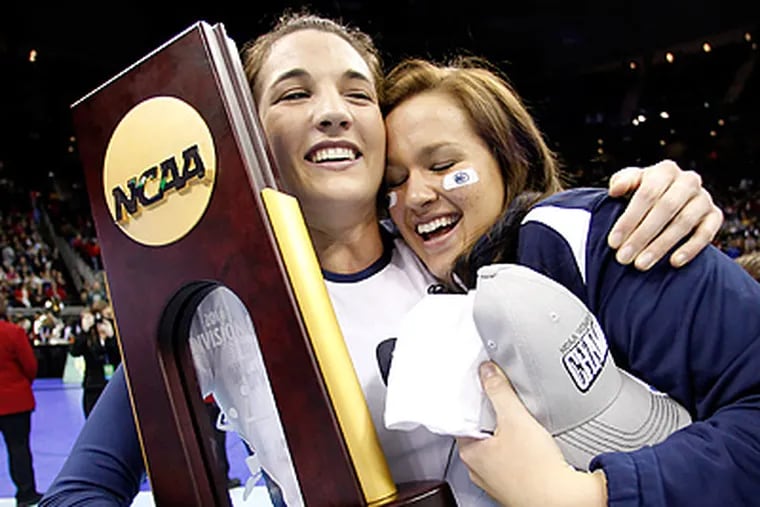 Blair Brown and Erica Denney celebrate after beating Cal to win the NCAA Division I Volleyball Championship. (AP Photo/Charlie Riedel)
