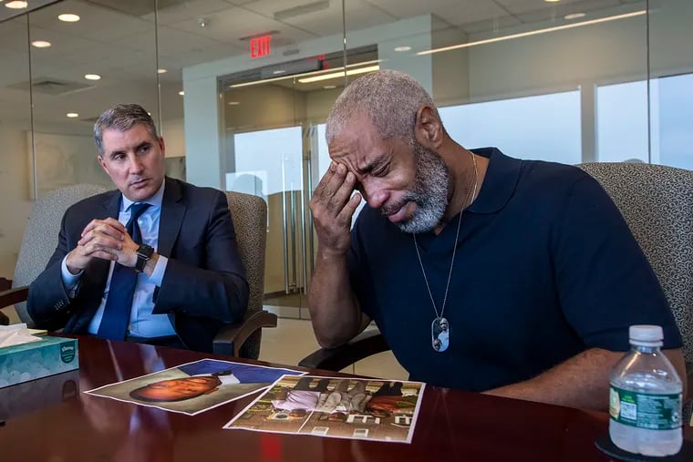 Rodney Hargrove (right) gets emotional next to his attorney, Gregory S. Spizer, during an interview with The Inquirer on Wednesday. Rodney's 20-year-old son, Rodney, was gunned down in the middle of the night in March as he waited for a ride outside the city jail after making bail.