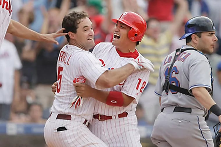Tadahito Iguchi is mobbed by Pat Burrell after Iguchi scored the winning run in the 10th inning Aug. 27, 2007, against the Mets. Iguchi drove in the tying run with a pinch-hit single.