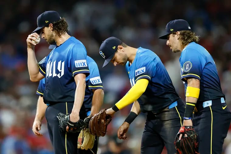 Phillies pitcher Aaron Nola reacts before getting replaced after giving-up six run to the Mets in the fifth inning.