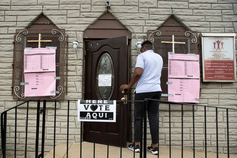 Rodney Ross arrives at the polling place at the Greater Mount Sinai Baptist Church on Election Day in the Point Breeze section of Philadelphia on Tuesday.