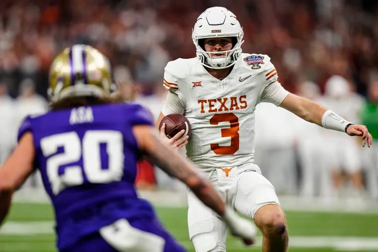 Texas quarterback Quinn Ewers (3) runs near Washington safety Asa Turner (20) during the first half of the Sugar Bowl CFP NCAA semifinal college football game, Monday, Jan. 1, 2024, in New Orleans. (AP Photo/Jacob Kupferman)